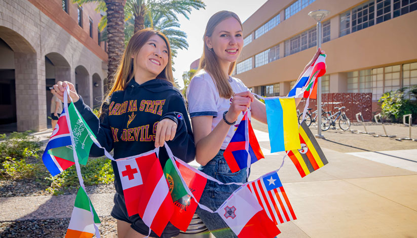 Two students holding flags