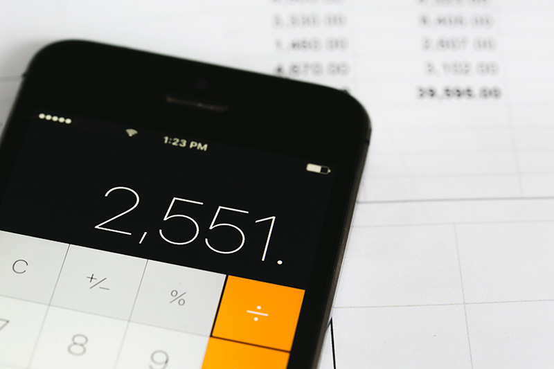 An iPhone calculator over a white spreadsheet