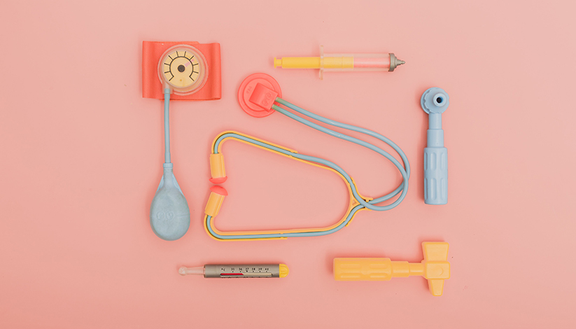 Image shows pastel plastic doctor's tools laying flat