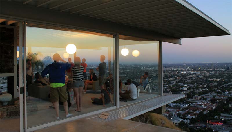 Students at a club meeting in a glass walled house