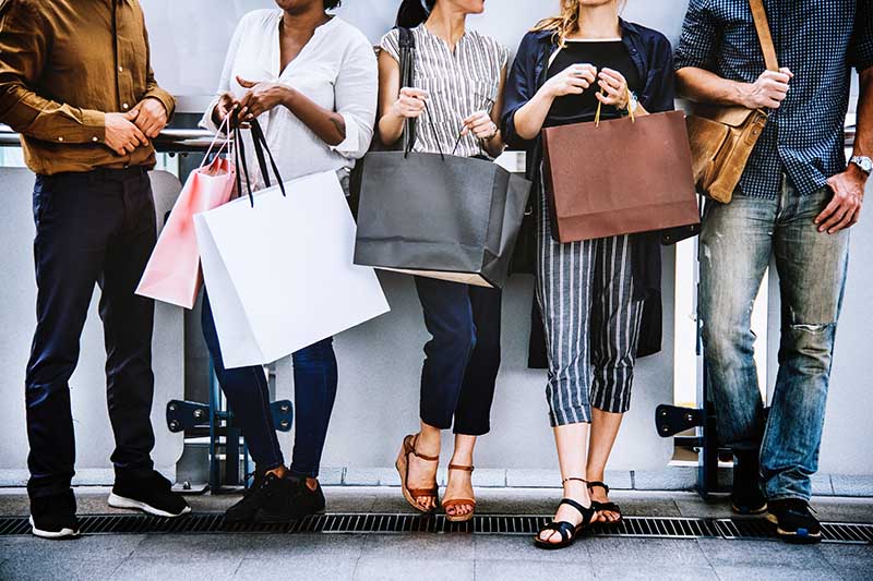 A group of people holding shopping bags