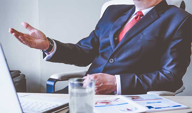 Person in suit sitting down 