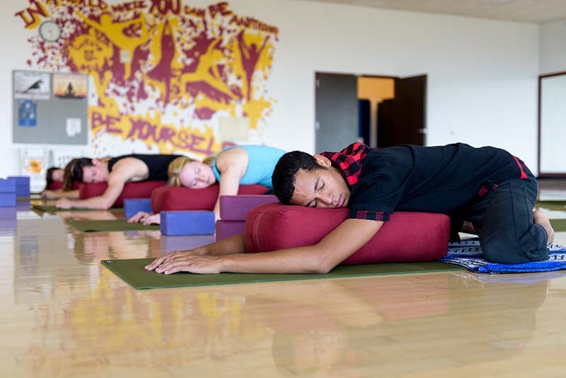 ASU students at the sun devil fitness complex doing yoga for wellness