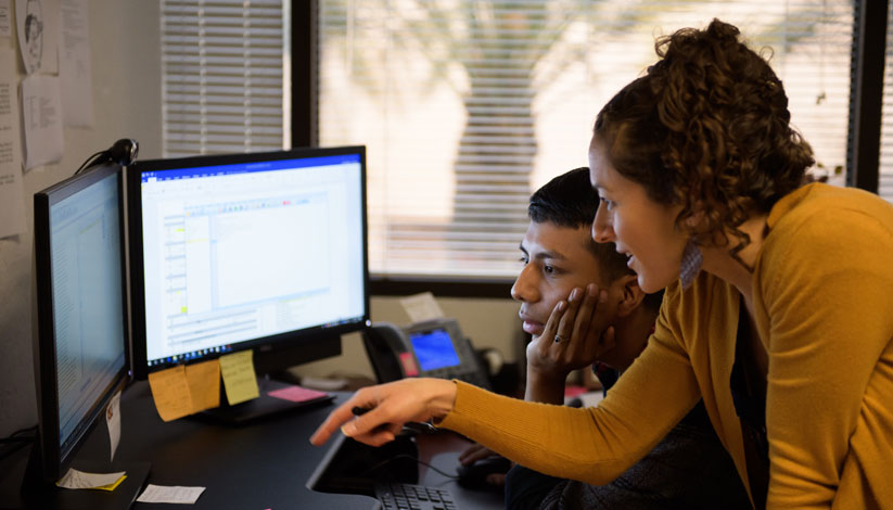 Two people using computer