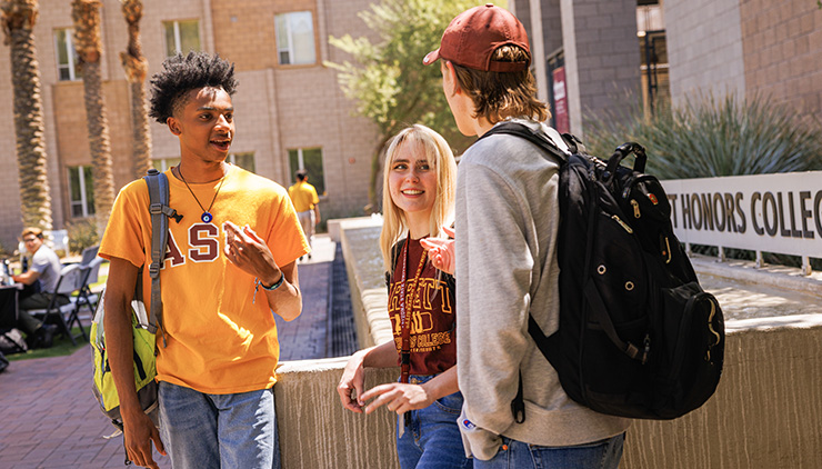 three students talking to each other